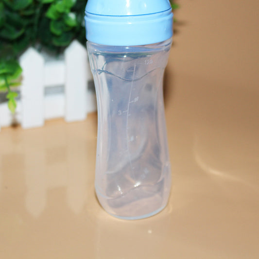 Clear bottle with blue cap on a beige surface