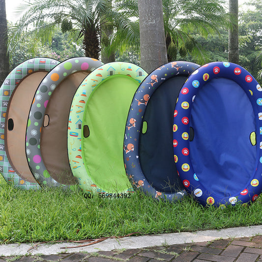 Colorful inflatable play tunnels on grass with a blurred background