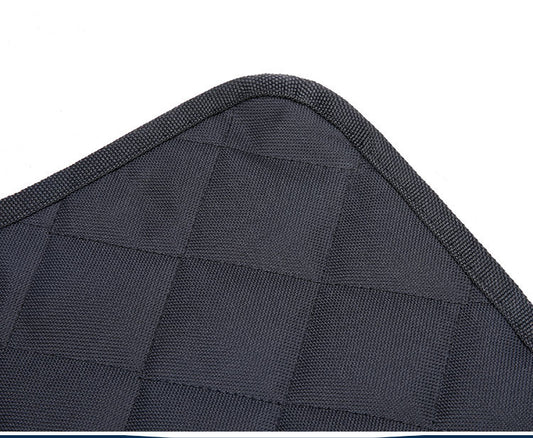 Close-up of a dark gray quilted seat cover with stitching details on a white background